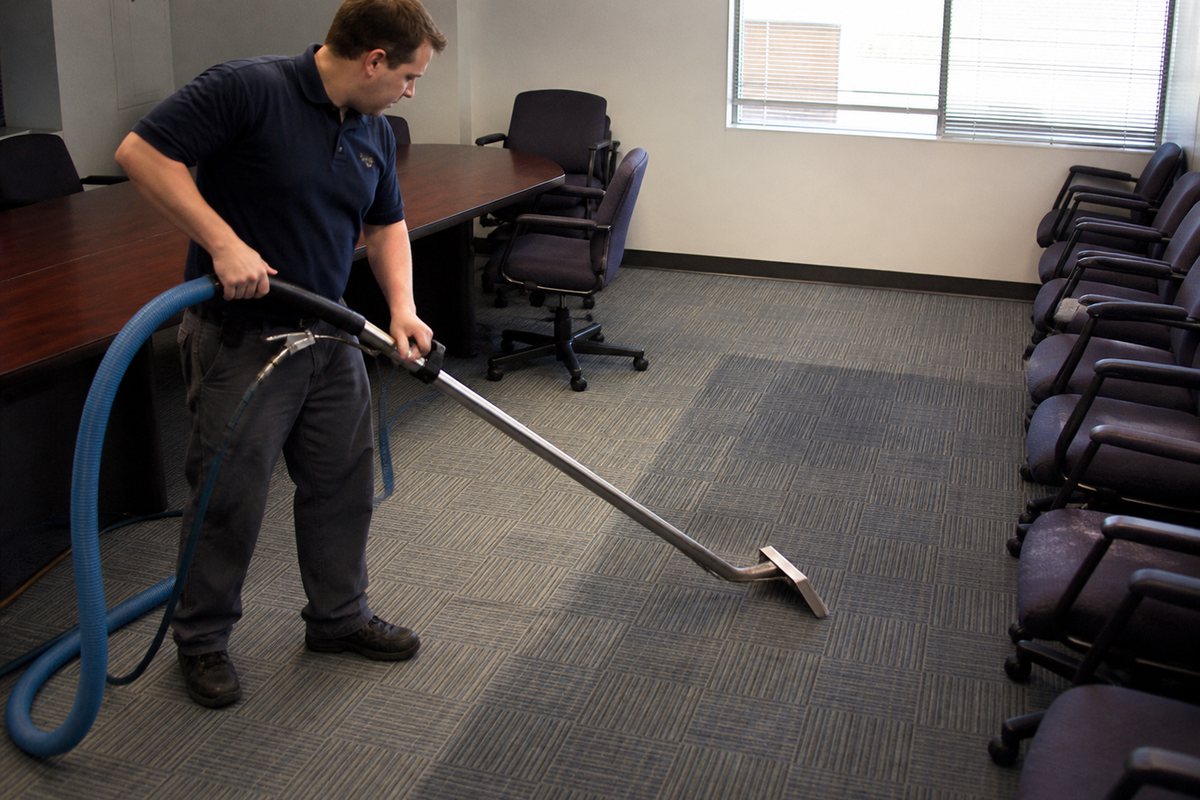 Cleaner extracting carpet in a commercial conference room